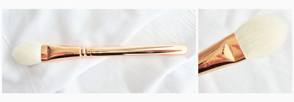 Pinceau Zoeva 114 Luxe Face Focus rose gold avec embout en forme de flamme.